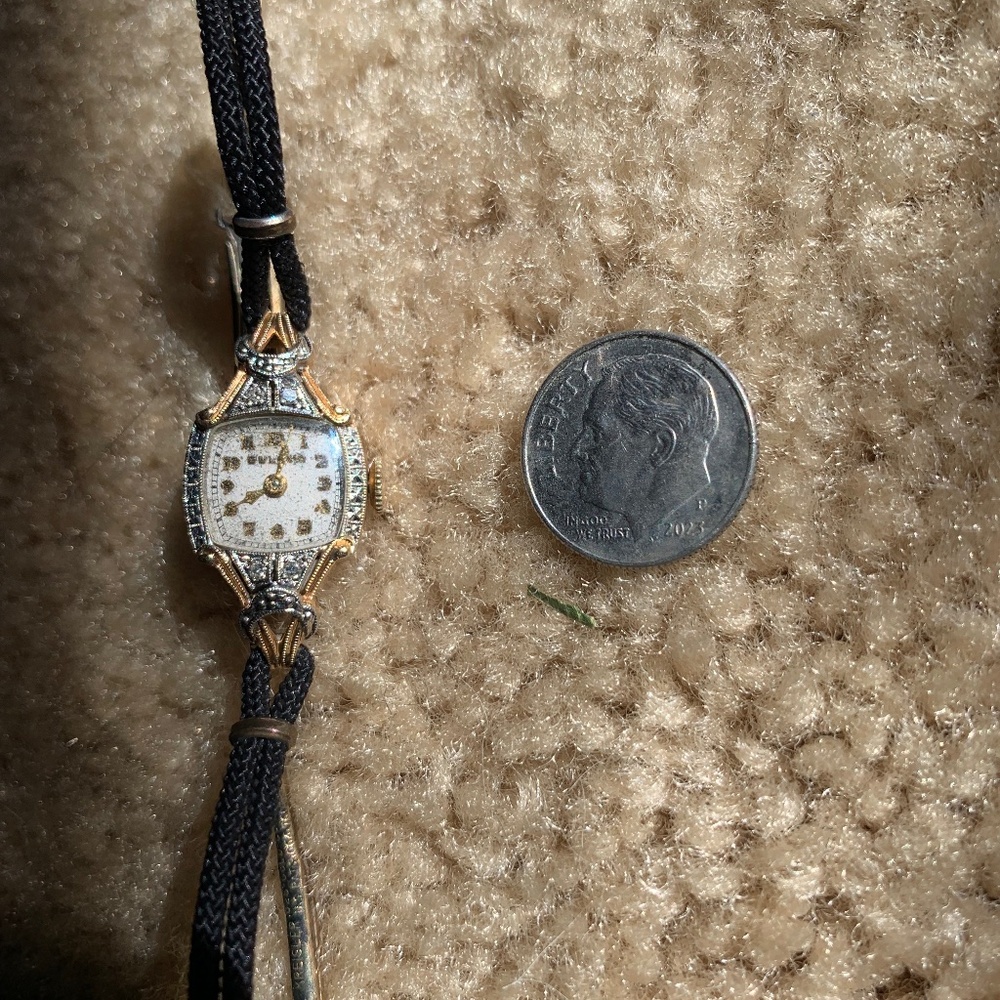 Women’s tiny 14k gold watch with strap band.